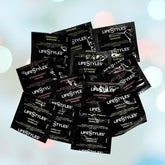 A selection of LifeStyles Assorted Flavors Lubricated Condoms 🍓🍌🍦, showcasing a variety of flavors such as banana, strawberry, and vanilla, is creatively displayed in a circular arrangement. The soft bokeh effect and pastel hues in the background enhance the presentation, making it ideal for adding an element of fun to oral sex.